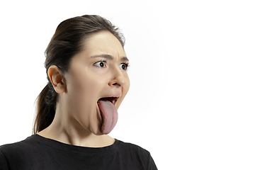 Image showing Smiling girl opening her mouth and showing the long big giant tongue isolated on white background, crazy and attracted