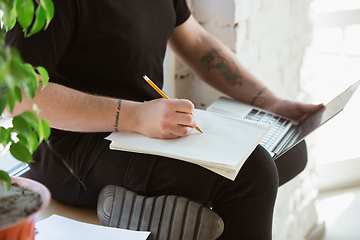 Image showing Young man studying at home during online courses for engineers, doctors, ecologists