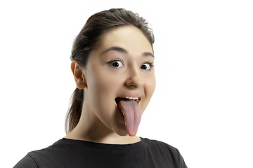 Image showing Smiling girl opening her mouth and showing the long big giant tongue isolated on white background, crazy and attracted