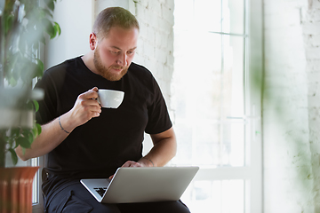 Image showing Young man studying at home during online courses for designers, consultants, IT-managers