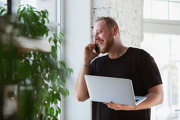 Image showing Young man studying at home during online courses for designers, consultants, IT-managers