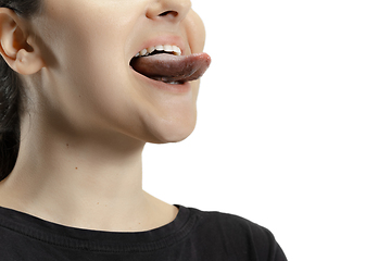 Image showing Smiling girl opening her mouth and showing the long big giant tongue isolated on white background, crazy and attracted