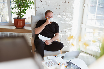 Image showing Young man studying at home during online courses for teacher, medical service manager