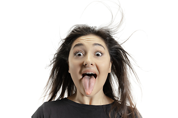 Image showing Smiling girl opening her mouth and showing the long big giant tongue isolated on white background, crazy and attracted