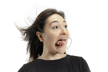 Image showing Smiling girl opening her mouth and showing the long big giant tongue isolated on white background, crazy and attracted