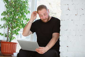 Image showing Young man studying at home during online courses for engineers, doctors, ecologists