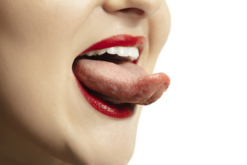 Image showing Smiling girl opening her mouth with red lips and showing the long big giant tongue isolated on white background, crazy and attracted, close up