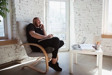 Image showing Young man studying at home during online courses for managers, marketers, buyers