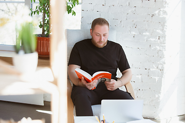 Image showing Young man studying at home during online courses for programmer, bug-tester, consulter