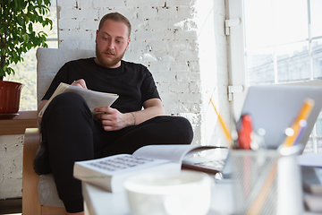 Image showing Young man studying at home during online courses for teacher, medical service manager