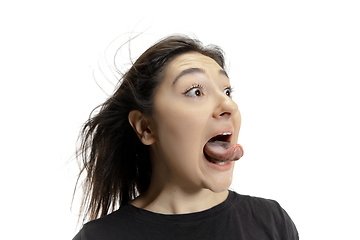 Image showing Smiling girl opening her mouth and showing the long big giant tongue isolated on white background, crazy and attracted