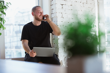 Image showing Young man studying at home during online courses for designers, consultants, IT-managers