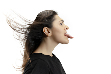 Image showing Smiling girl opening her mouth and showing the long big giant tongue isolated on white background, crazy and attracted