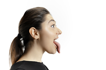 Image showing Smiling girl opening her mouth and showing the long big giant tongue isolated on white background, crazy and attracted