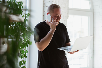 Image showing Young man studying at home during online courses for designers, consultants, IT-managers