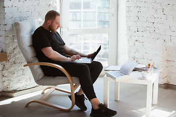 Image showing Young man studying at home during online courses for programmer, bug-tester, consulter