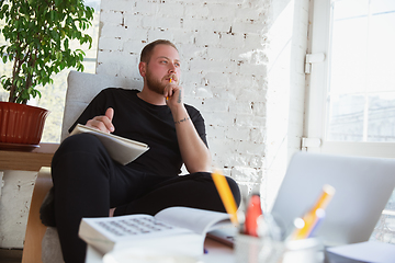 Image showing Young man studying at home during online courses for teacher, medical service manager