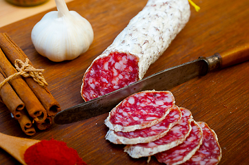 Image showing traditional Italian salame cured sausage sliced on a wood board