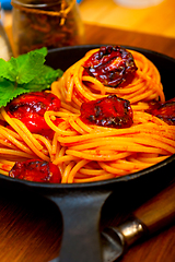 Image showing italian spaghetti pasta and tomato with mint leaves