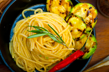 Image showing italian spaghetti pasta with zucchini sauce on iron skillet