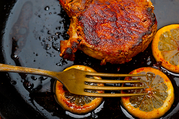 Image showing pork chop seared on iron skillet