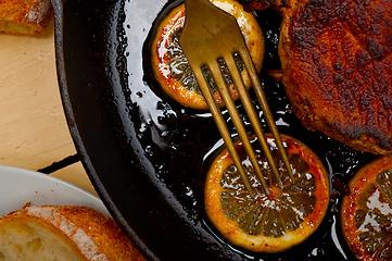 Image showing pork chop seared on iron skillet