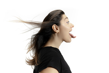 Image showing Smiling girl opening her mouth and showing the long big giant tongue isolated on white background, crazy and attracted