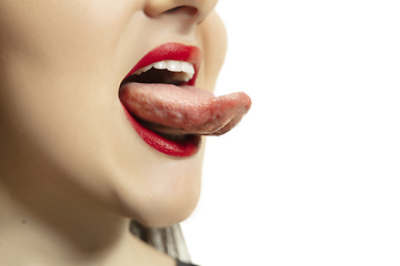 Image showing Smiling girl opening her mouth with red lips and showing the long big giant tongue isolated on white background, crazy and attracted, close up