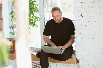 Image showing Young man studying at home during online courses for designers, consultants, IT-managers