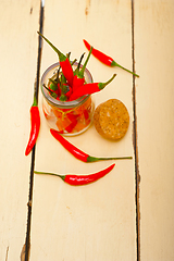 Image showing red chili peppers on a glass jar