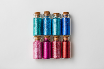 Image showing set of glitters in bottles over white background