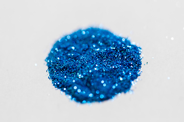 Image showing blue glitters on white background