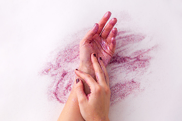 Image showing hands with glitters on white background