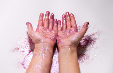 Image showing hands with glitters on white background