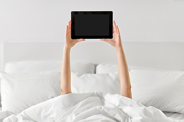 Image showing hands of woman lying in bed with tablet computer