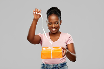 Image showing happy african american woman with gift box