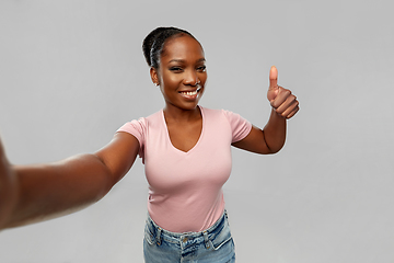 Image showing african woman taking selfie and showing thumbs up