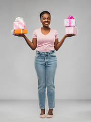 Image showing happy african american woman with gift boxes