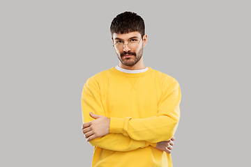 Image showing young man in glasses and yellow sweatshirt