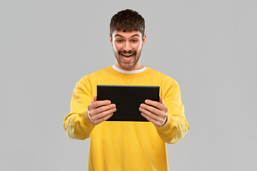 Image showing smiling young man with tablet pc computer