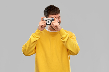 Image showing young man with vintage film camera