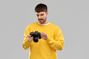 Image showing young man with digital camera