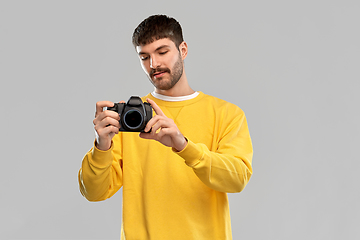 Image showing young man with digital camera