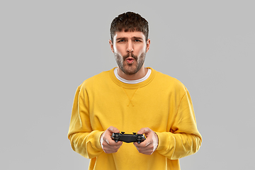 Image showing man or gamer with gamepad playing video game