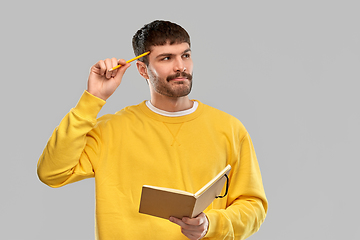 Image showing thinking man with diary and pencil