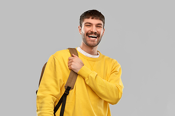 Image showing happy smiling young man with backpack