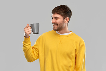 Image showing happy smiling young man with coffee cup