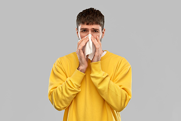 Image showing man with paper napkin blowing nose