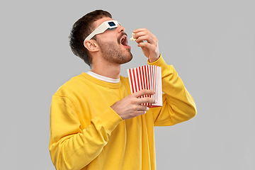 Image showing man 3d movie glasses eating popcorn