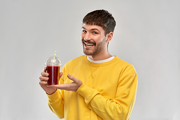 Image showing happy man with tomato juice in takeaway cup